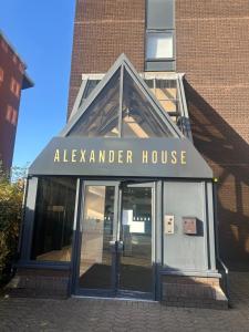 an entrance to aaza member house in front of a building at Elegant 1 Bed Flat Near Stadium & Shops and free parking in Manchester