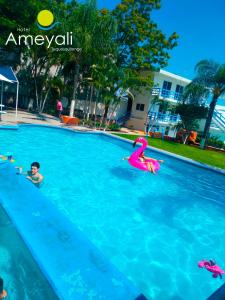 a group of people swimming in a swimming pool at Ameyali Teques in Tequesquitengo