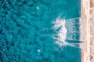 an overhead view of a pool of blue water at Luxury VILLA RAFAEL in Skopelos Town