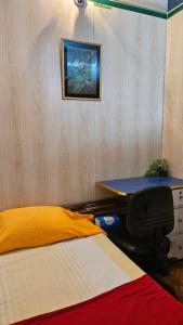 a bedroom with two beds and a table in it at Sky Garden Home in Dhaka