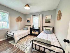 a bedroom with two beds and a window at Restful Retreat with 4 Beds Sleeps 6 in Valdosta
