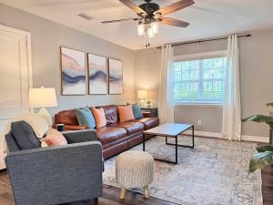 a living room with a couch and a ceiling fan at Restful Retreat with 4 Beds Sleeps 6 in Valdosta