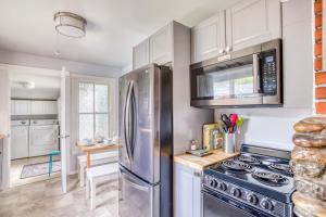 a kitchen with a stove and a refrigerator at Whales Cove in Waldport