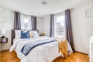 a bedroom with a large bed with blue pillows at Whales Cove in Waldport