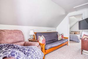 a living room with a couch and a tv at Whales Cove in Waldport