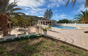 a house with a swimming pool and palm trees at Pet Friendly Home In Elda in Almafrá +46 photos