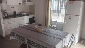 a kitchen with a table with a basket on it at Cabañas Esmeralda in Villa Ciudad de America