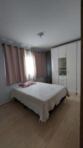 Ένα ή περισσότερα κρεβάτια σε δωμάτιο στο Casa aconchegante no Balneário de Ipanema