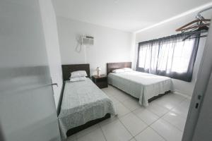 Postel nebo postele na pokoji v ubytování BRUNO KLEMTZ DS1 - CASA COM PISCINA, PARQUE INFANTIL E SALA DE JOGOS- 2 dorm - MEIA PRAIA - ITAPEMA + 28 fotografií