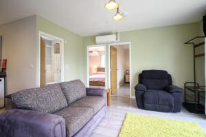 a living room with a couch and a chair at Gwel An Koos in Bodmin