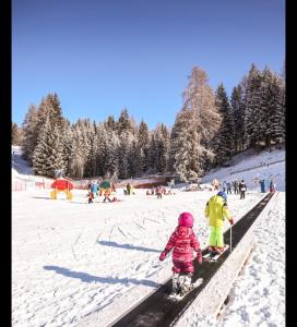 a group of children on skis in the snow at Appartamento vista Baranci in San Candido
