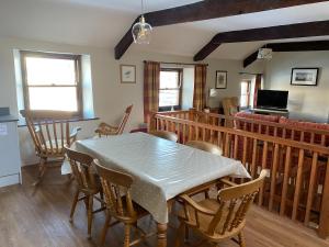 a dining room with a table and chairs at 5 Swallowholm Cottages in Richmond