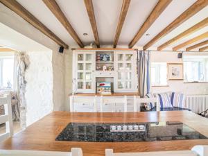 a dining room with a table and chairs at Tir A Mor in Nefyn +22 photos