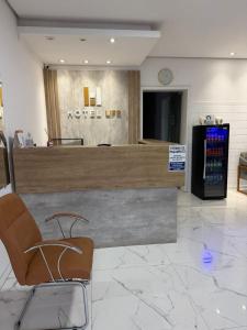a hotel lobby with a ticket counter and a chair at Hotel Life Ijui in Ijuí