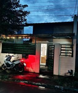 ein Motorrad, das vor einem kleinen Haus parkt in der Unterkunft Gee Staycation in Santo Tomas