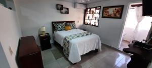 a bedroom with a bed in a white room at Puerto Plata Home in San Felipe de Puerto Plata