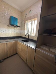 a small kitchen with a sink and a window at Palazzo Apartments in Ikeja
