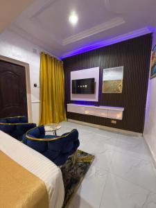 a hotel room with a bed and a tv at Palazzo Apartments in Ikeja +72 photos