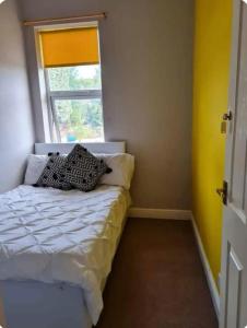 a bedroom with a bed with two pillows on it at Modern Double Rooms Near Stoke City Centre and Staffordshire Uni in Stoke on Trent