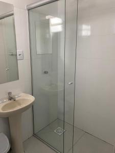 a bathroom with a glass shower and a sink at Hotel Life Ijui in Ijuí