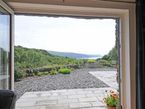 a sliding glass door to a patio with a view at Bryn Derw in Barmouth