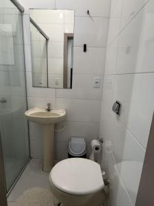 a small bathroom with a toilet and a sink at Hotel Life Ijui in Ijuí +30 photos