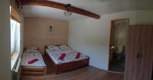 a bedroom with two beds in a room at Noclegi W Sadzie in Rajcza