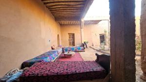 a living room with two couches and a table at Dar salam in Mhamid