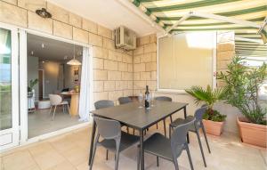 a dining room with a table and chairs at Nice Apartment In Selca With Kitchen in Selca +23 photos