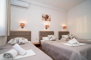 a room with two beds with towels on them at Pansion Milena i Mario in Međugorje +70 photos