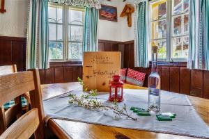 a table with a bottle of wine and a candle on it at Vordersattlegghofhütte in Hüttau