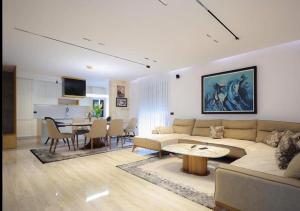 a living room with a couch and a table at Apartament Modern in Kosovo Polje