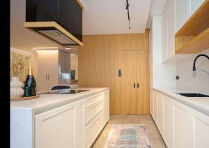 a kitchen with white cabinets and a sink at Apartament Modern in Kosovo Polje
