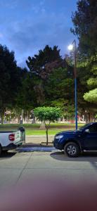 a blue car is parked next to a street light at Apart Brumato in Catriel