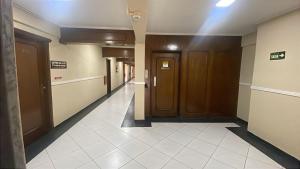 a hallway of a hospital with doors and tile floors at Hotel Vitória de Santos in Santos