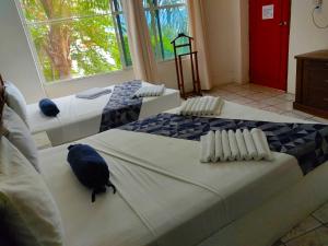 two beds in a room with a bird sitting on them at Ameyali Teques in Tequesquitengo