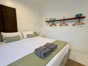 a bedroom with a bed with two towels on it at Orchid Villa in Koh Tao +10 photos