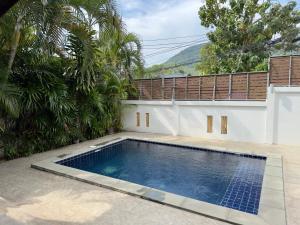 a swimming pool in the backyard of a house at Orchid Villa in Koh Tao
