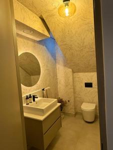 a bathroom with a sink and a toilet at Views on August - Penthouse Unit 9 in Cape Town