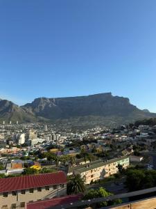 a view of a city with mountains in the background at Views on August - Penthouse Unit 9 in Cape Town +3 photos