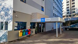 a row of parking meters in front of a building at ibis budget Divinopolis in Divinópolis