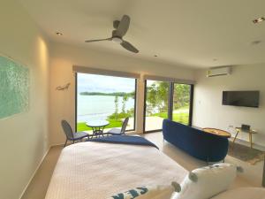 a living room with a large bed and a large window at Villa Sea La Vie in Boca Chica