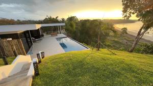 a house with a swimming pool and a view of the water at Villa Sea La Vie in Boca Chica