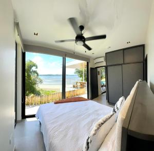 a bedroom with a bed and a ceiling fan at Villa Sea La Vie in Boca Chica +24 photos