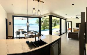 a kitchen with a sink and a table with a view at Villa Sea La Vie in Boca Chica