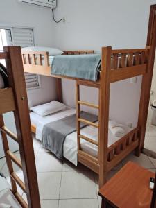a room with two bunk beds and a table at Pousada São Nicolau in Cachoeira Paulista +9 photos