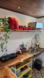a kitchen with a sink and a counter top at Le Ville - Campos do Jordão in Campos do Jordão