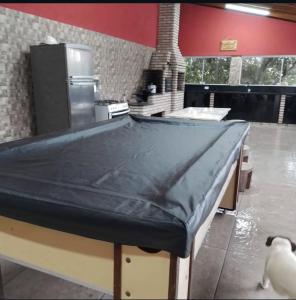 a kitchen with a table with a counter top at Chácara Amorim in Mairiporã