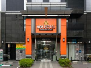 an entrance to a hotel with an orange facade at APA Hotel Nagoya Sakae Higashi in Nagoya