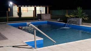 a swimming pool at night with a fountain at Aires de Primavera in San Rafael